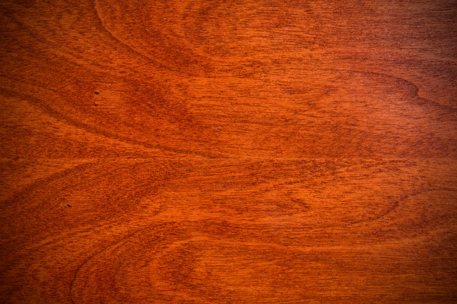 Closeup of natural cherry hardwood with grain detail.