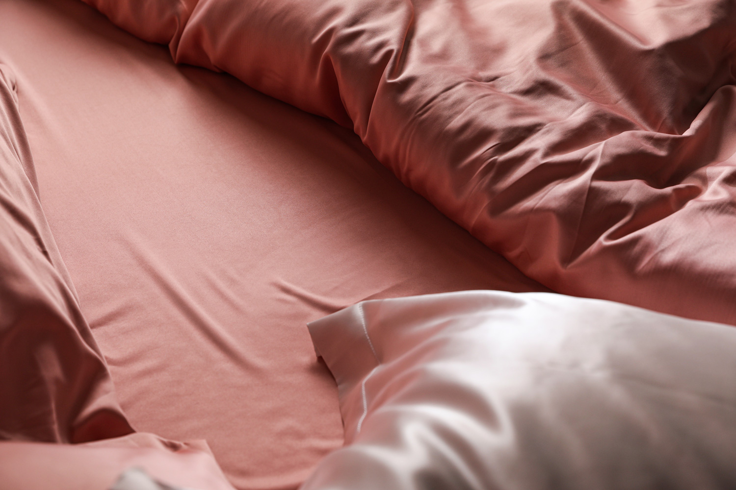 Closeup view of bed with beautiful silk linens
