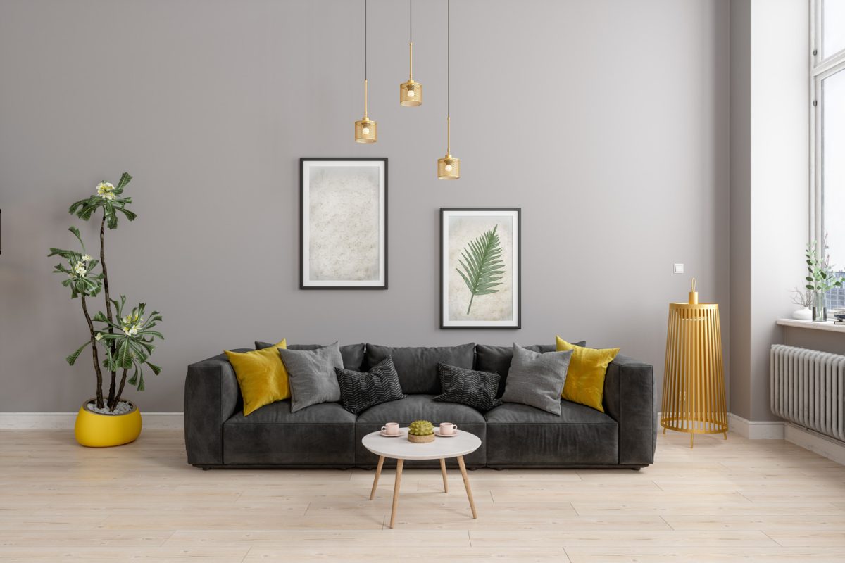 Front View Of Modern Living Room With Yellow Sconce, Gray Sofa And Yellow Pillows - What Color Floors Go With Gray Walls