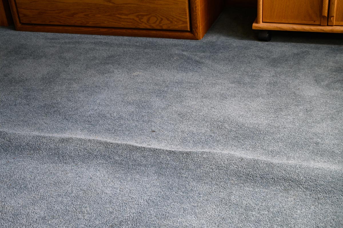 A furniture in the room with wrinkled carpet, How To Get Creases Out Of The Carpet