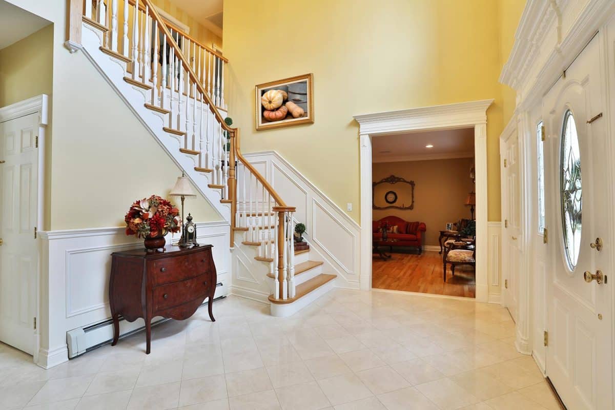 Granite tile and staircase upon entering elegant home