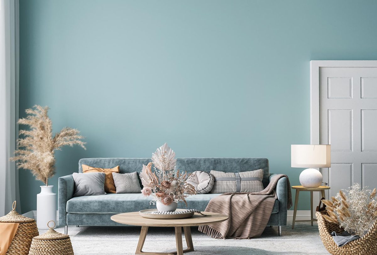 Home interior mock-up with blue sofa, wooden table and decor in blue living room