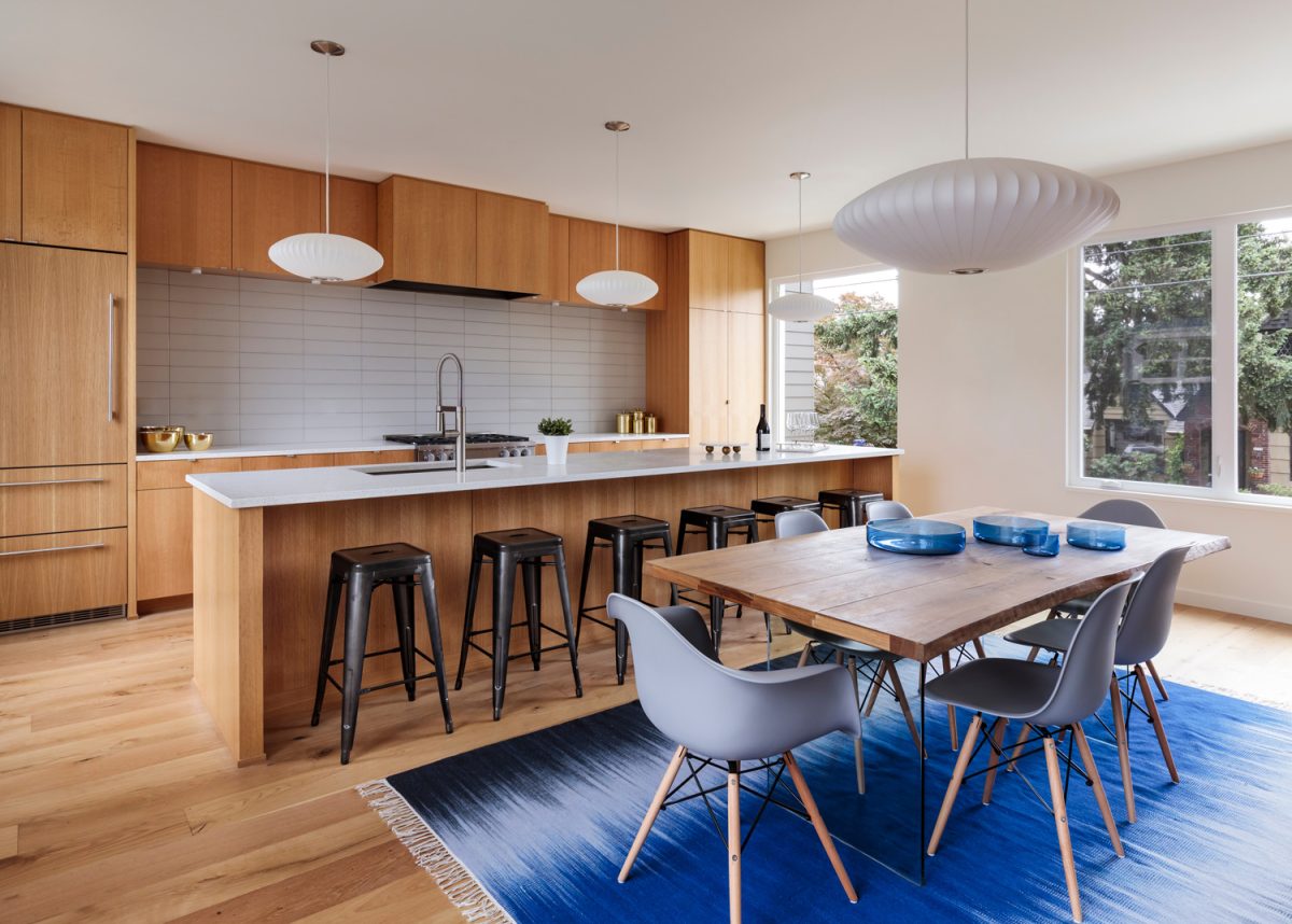Mid-century modern kitchen with custom wood cabinets and blue accents.