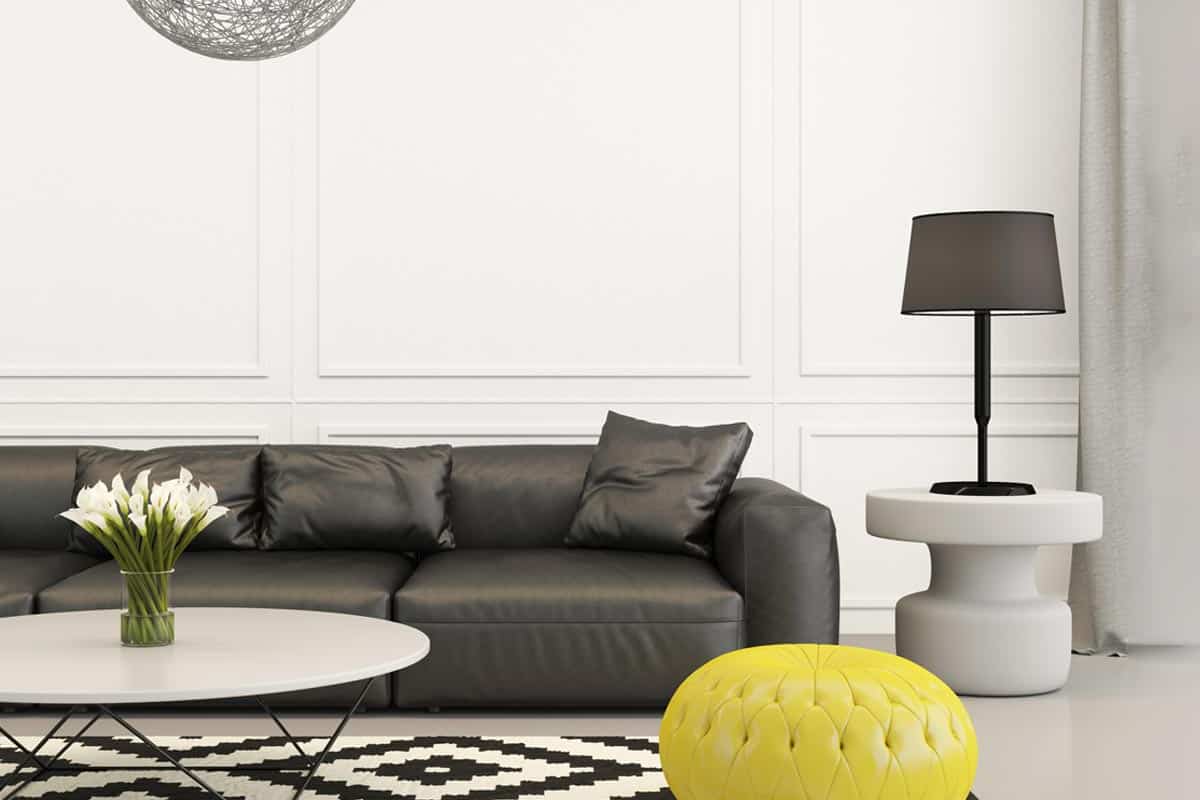 A modern living room in black and white with yellow seat, What Wall Color Goes With Black And White Furniture?