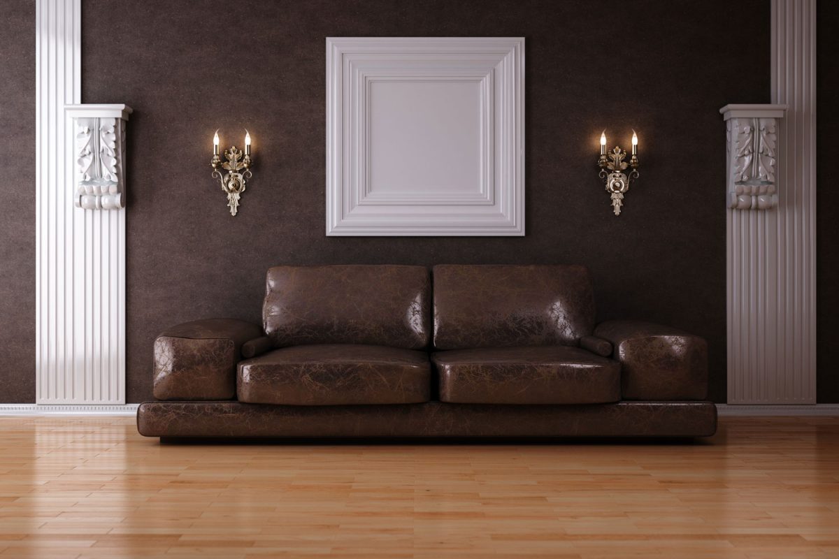 Modular leather sofa with brown walls and wooden flooring and mid century designed columns