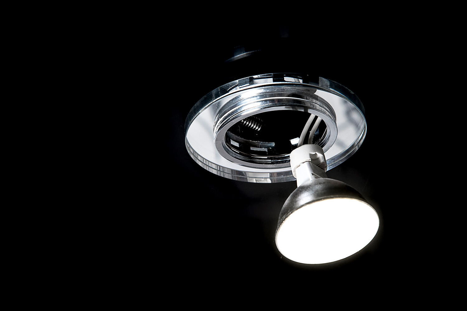 Mounting led ceiling lamp or recessed halogen lights on black suspended ceiling in room, close up.