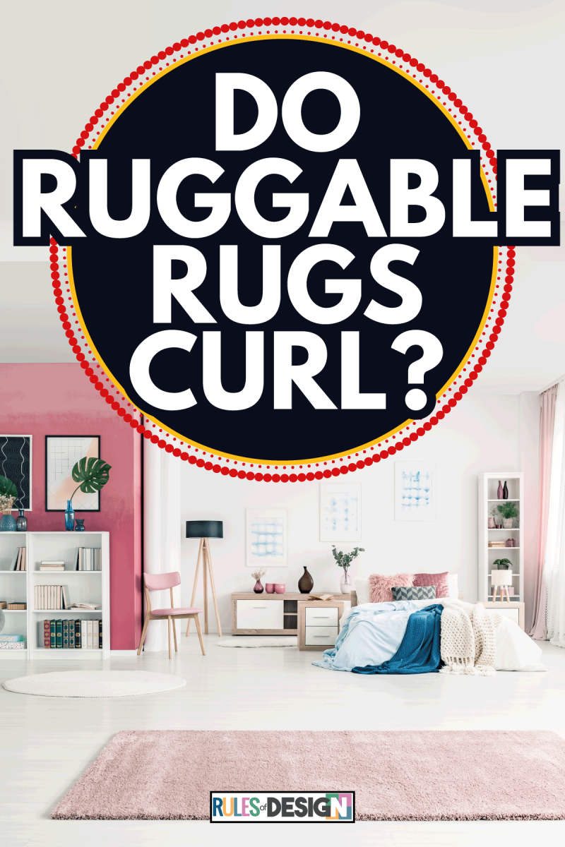 Open space bedroom interior with big rug, cozy bed, pink and white walls, chairs. Do Ruggable Rugs Curl