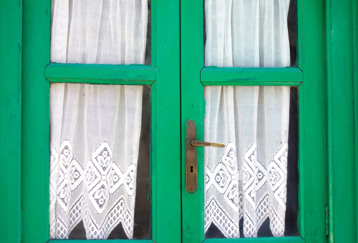 Rustic Green Wood French Doors with Lace Curtains Close-Up.