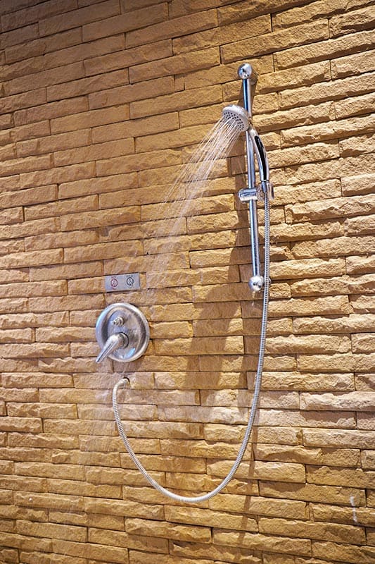 Shower on tiles and chrome fittings