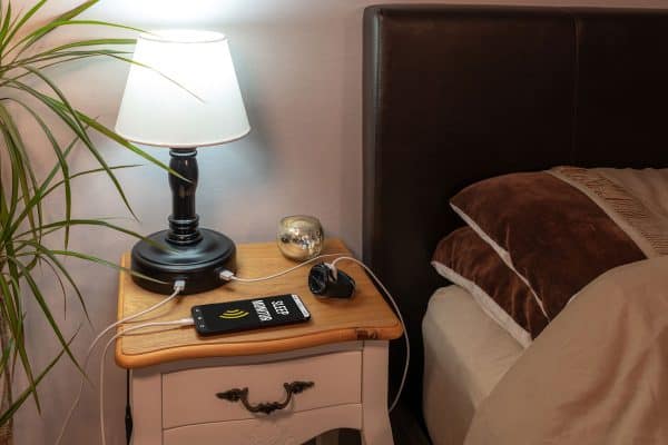 Smartphone with a "Sleep Monitor" app running, plugged into a smart USB lamp, Do You Really Need Two Nightstands?