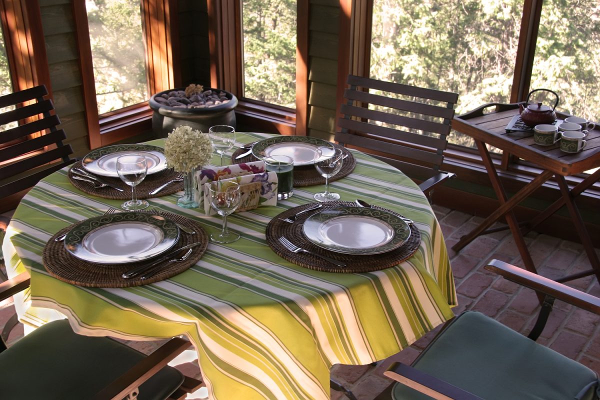 Table setting for four on the screened in Porch.
