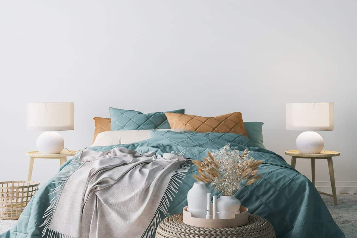 Teal and brown beddings paired with wooden nightstands