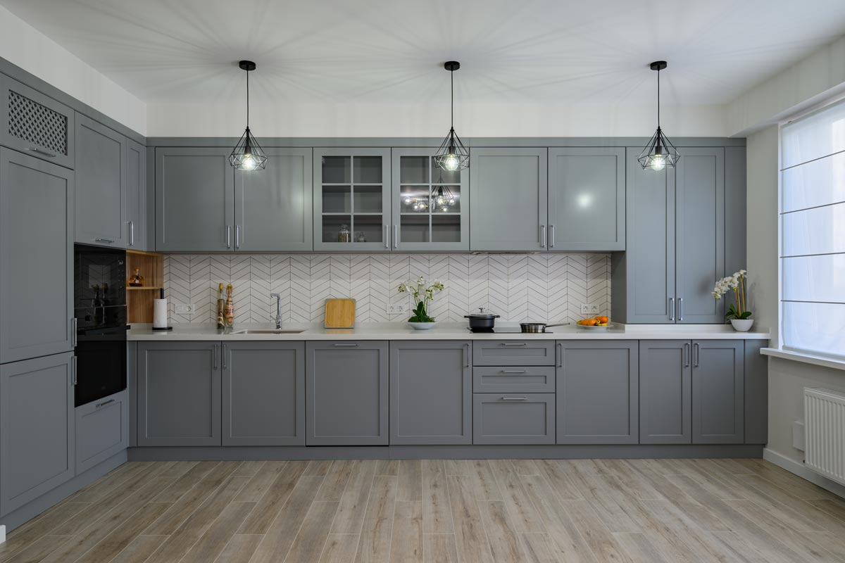 A trendy gray and white modern kitchen furniture showcase, Should Wood Floors Be Lighter Or Darker Than Cabinets?
