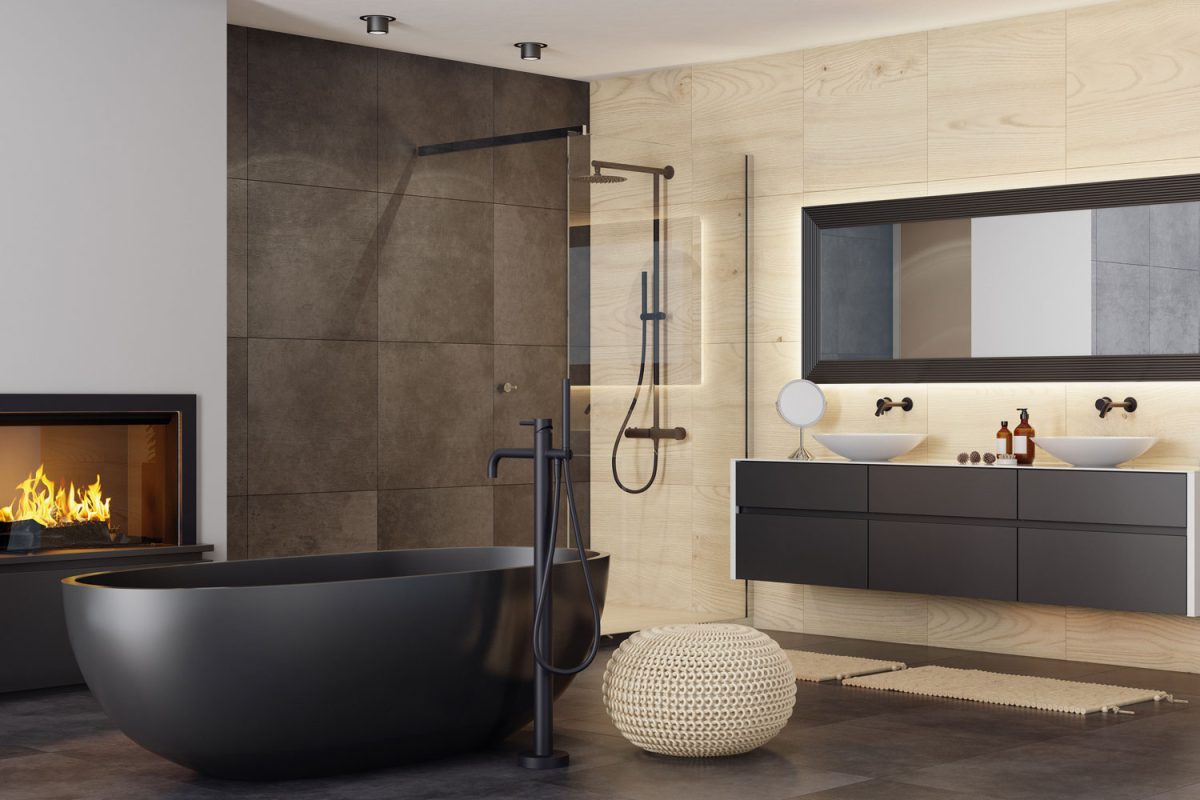 Ultra luxurious bathroom with a black bathtub with black painted fixtures and a matching fireplace