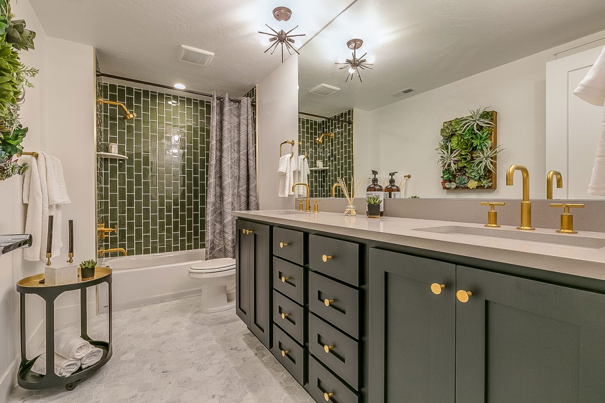 Ultra luxurious modern bathroom with a huge vanity mirror matched with green paint cabinets