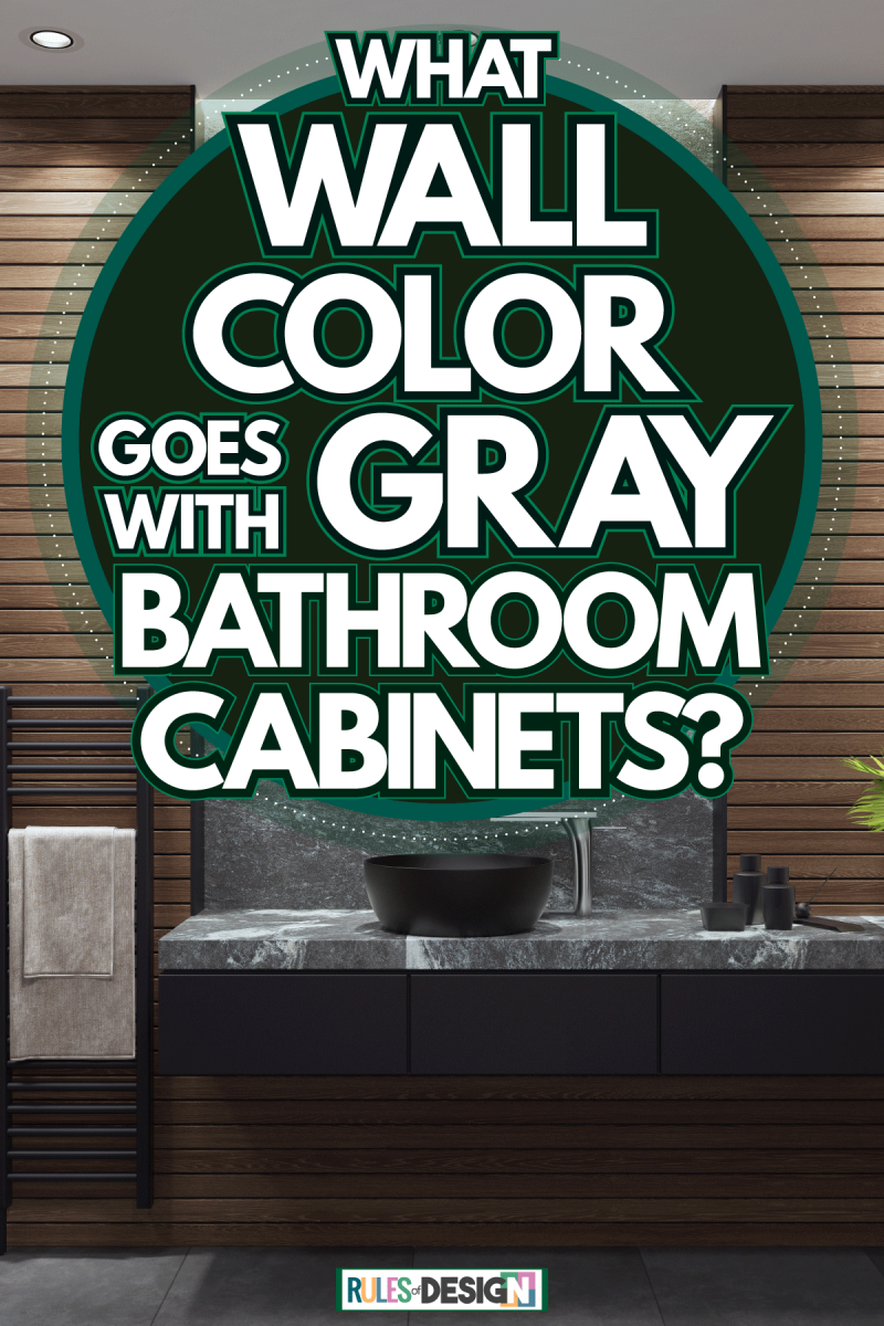 Interior of a gorgeous bathroom with wooden paneling walls, a black cabinet with plants and matched with a huge round mirror, What Wall Color Goes With Gray Bathroom Cabinets?
