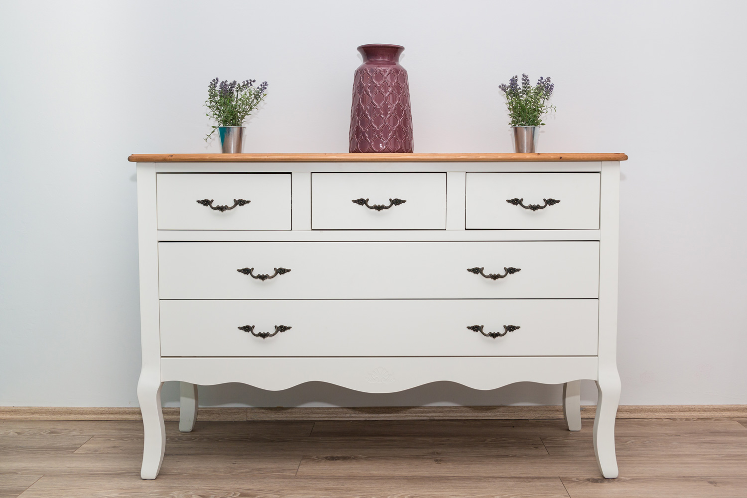 White wooden dresser with three vases and flowers on white wall background. - How To Paint An IKEA MALM Dresser