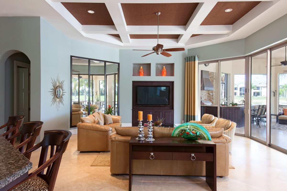 Wood tones home interior in den state home with matching wood fan and ceiling