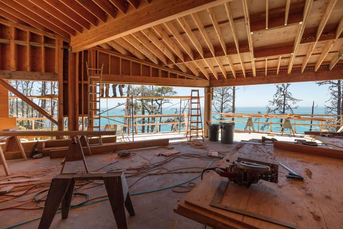 Wooden framing and construction equipment's inside a lake house undergoing construction