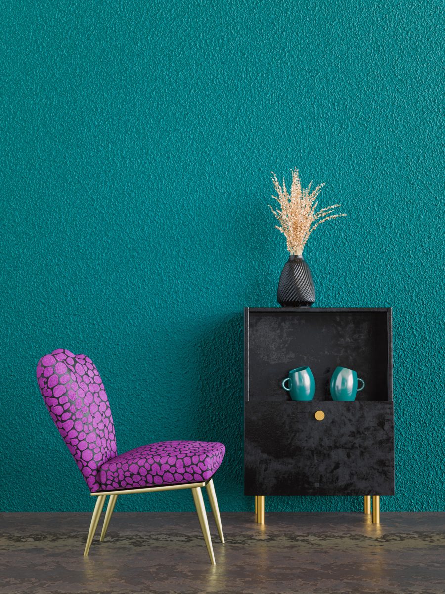 room with a purple chair and a little sideboard with cups and a plant