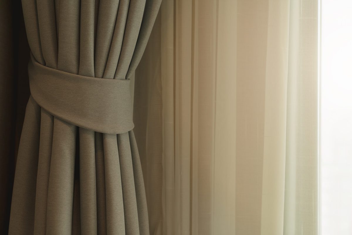 soft brown curtain with morning light from window bedroom background

