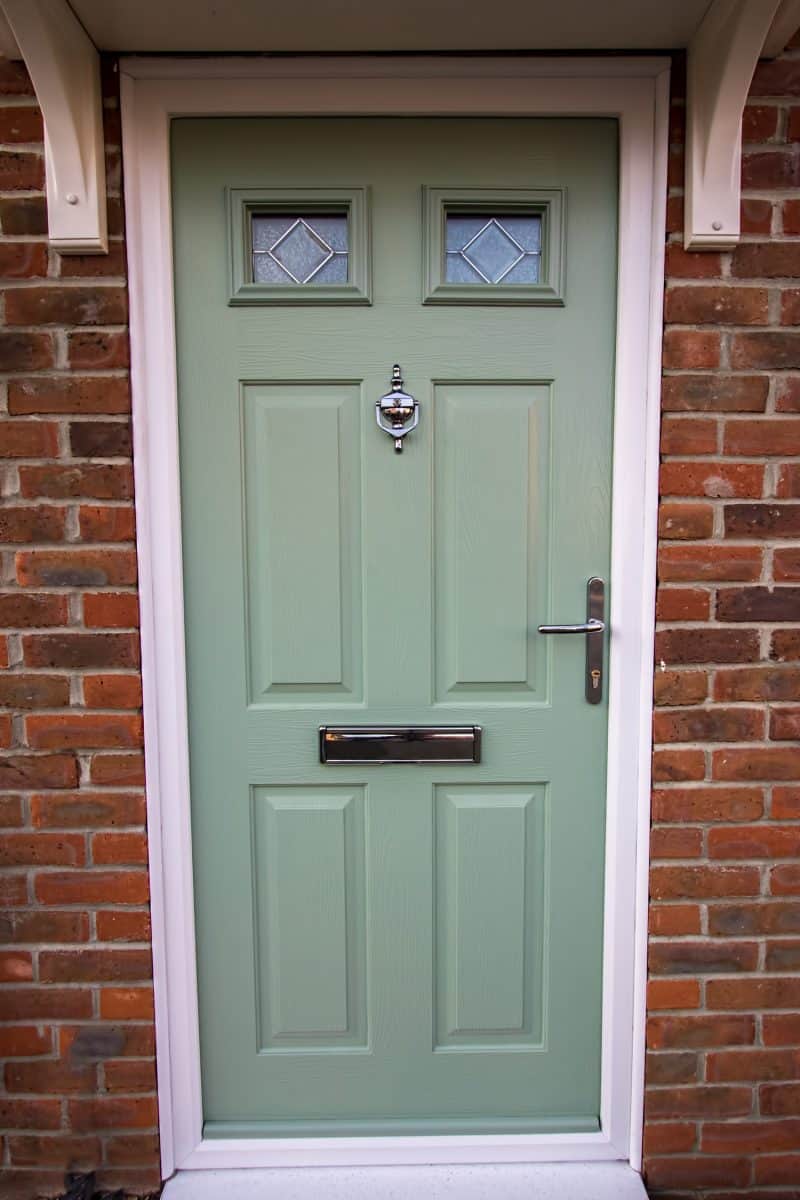 Green door. Modern house composite upvc front door with chrome hardware. 